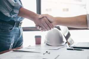 Contractor and client shaking hands